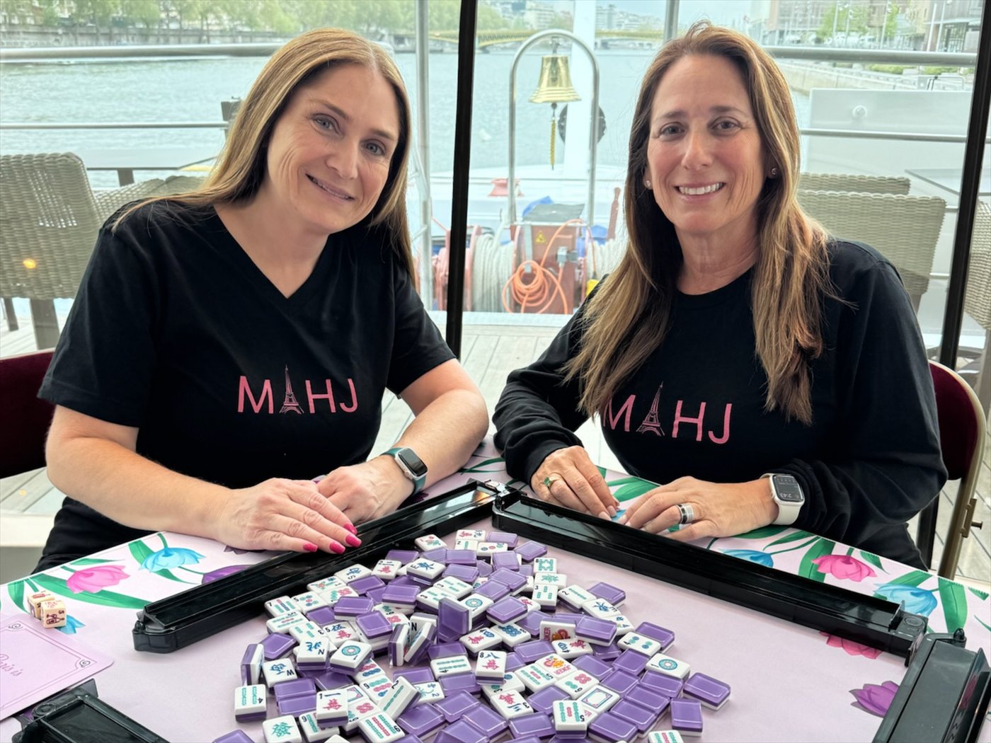 Jill Fox and Susan Bishop playing Mah Jongg on board