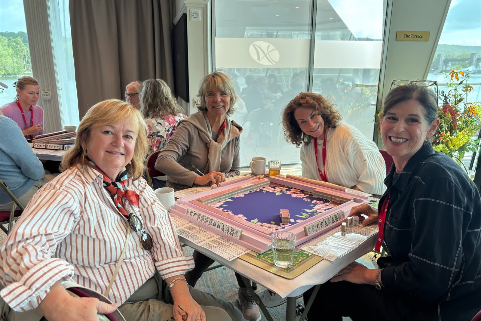 Guests playing Mah Jongg at a table on board