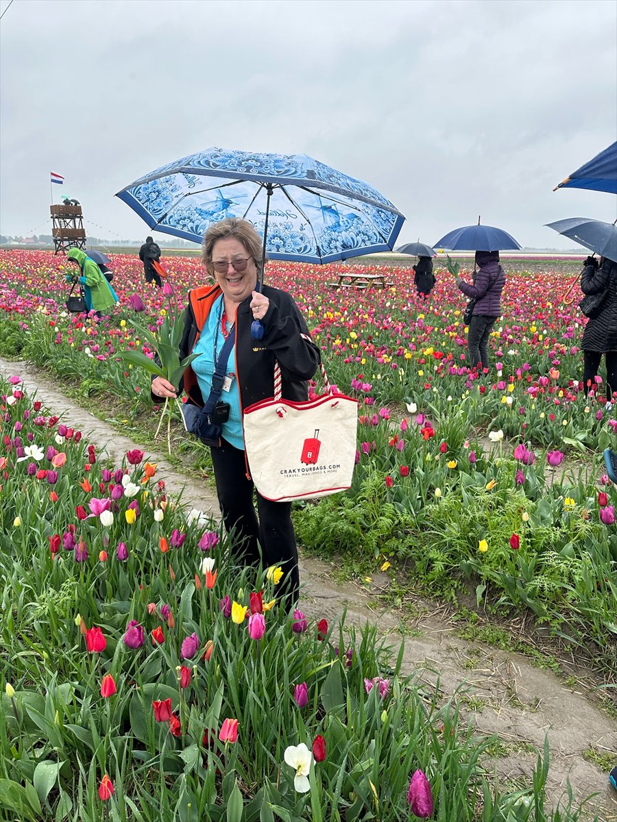 A guest carrying a Crak Your Bags tote in a Dutch tulip field